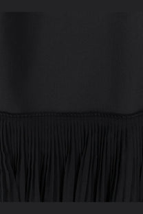 Black pleated fabric hem of rohe womens pleated long dress showcasing elegant flow and texture