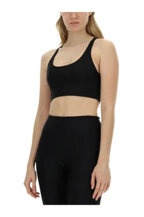 Black seamless sports bra with wide shoulder straps and cropped design by rotate birger christensen women