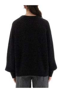Black textured knit sweater with loose fit and bell sleeves from Rotate Birger Christensen women’s lightweight jersey collection