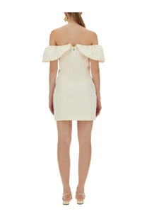 Off-the-shoulder cream mini dress with puffed sleeves and central back zipper by Rotate Birger Christensen shown from back