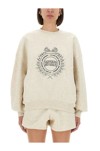 Cream-colored oversized rotate birger christensen women’s sweatshirt with black circular floral wreath graphic