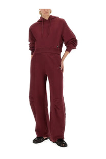 Rotate birger christensen women’s maroon terry back cropped hoodie with drawstring hood and ribbed cuffs paired with wide-leg pants
