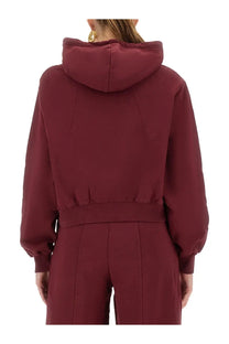 Rotate Birger Christensen women’s red terry back cropped hoodie with ribbed waistband and long sleeves shown from back side