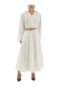 White embroidered two-piece wrap around shirt top with long sleeves and flowing skirt by rotate birger christensen