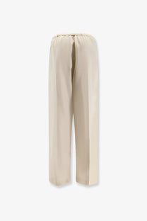 The Row women’s Beta silk trousers in beige feature wide-leg design and an elastic waistband with flowing fabric