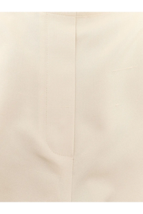 Cream-colored cotton shirt with subtle ribbed texture and neat stitching paired with the row women’s beta silk trousers white