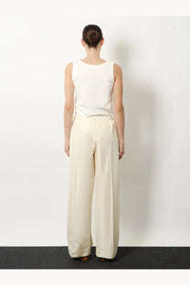 The row women’s beta silk trousers white are cream-colored wide-leg pants with smooth fabric and an elastic waistband