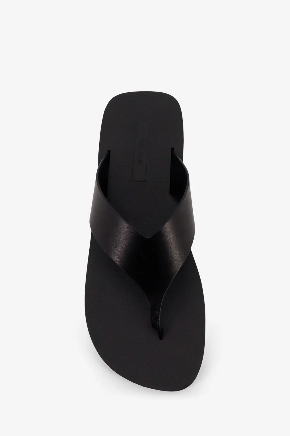 The row women’s dune classic ginza leather sandals black featuring black leather flip-flops with a glossy finish