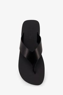 The row women’s dune classic ginza leather sandals black featuring black leather flip-flops with a glossy finish
