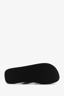 Black rubber sole with textured surface of the row women’s dune classic ginza leather sandals black back view