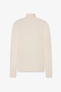 The row women’s lizzy cashmere top is a cream-colored long-sleeved turtleneck sweater with smooth knit texture