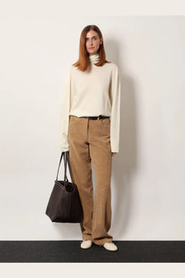 The Row women’s Lizzy cashmere top white cream-colored long-sleeved turtleneck sweater with soft knit texture