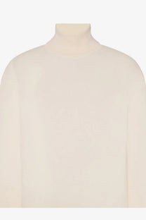The row womens lizzy cashmere top is a cream-colored long-sleeved turtleneck sweater with a soft smooth texture