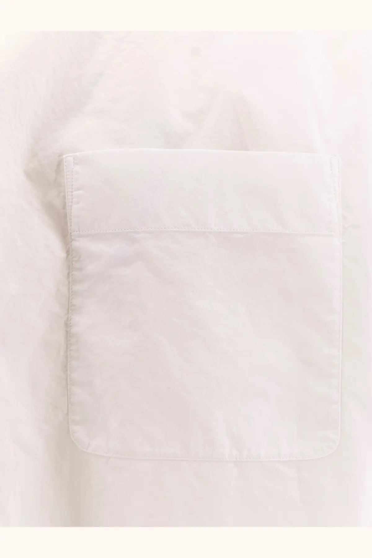 White fabric pocket with neat stitching and soft cotton texture on the row women’s victoria cotton shirt white
