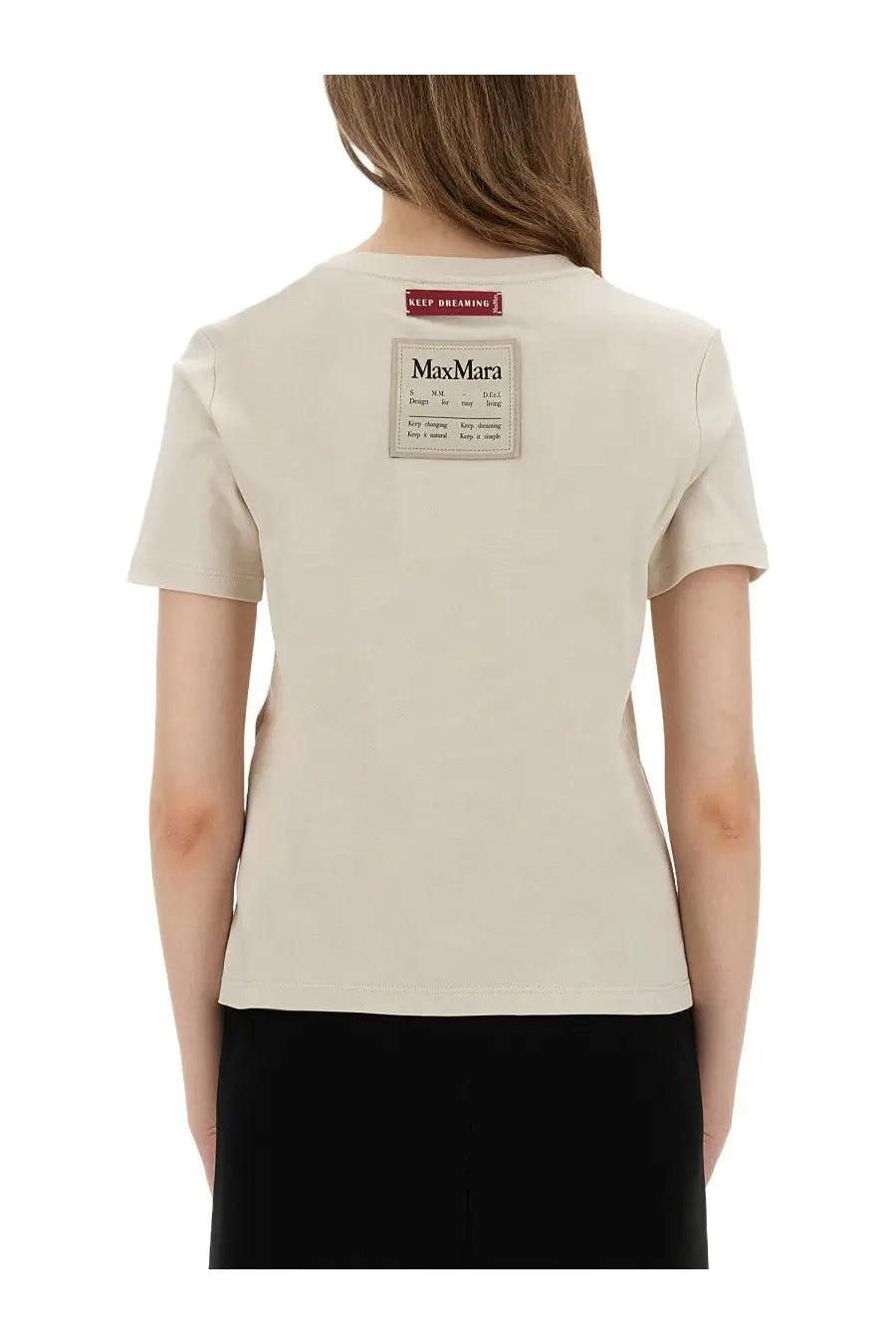 Back of beige s max mara women’s bud shirt with rectangular black text label patch and small red tag on cotton fabric