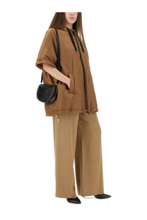 Black leather crossbody bag with gold zipper detail paired with s max mara women’s greenci beige padded jacket