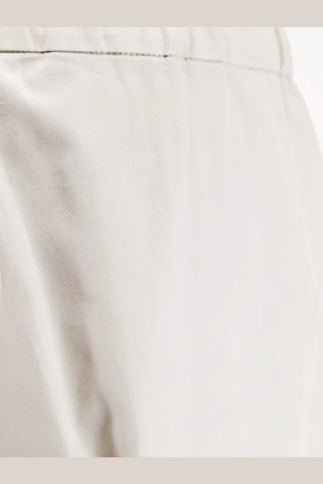 A close-up of white satin fabric with subtle sheen and fine stitching on s max mara smmargento vissuto cotton trousers ghiaccio