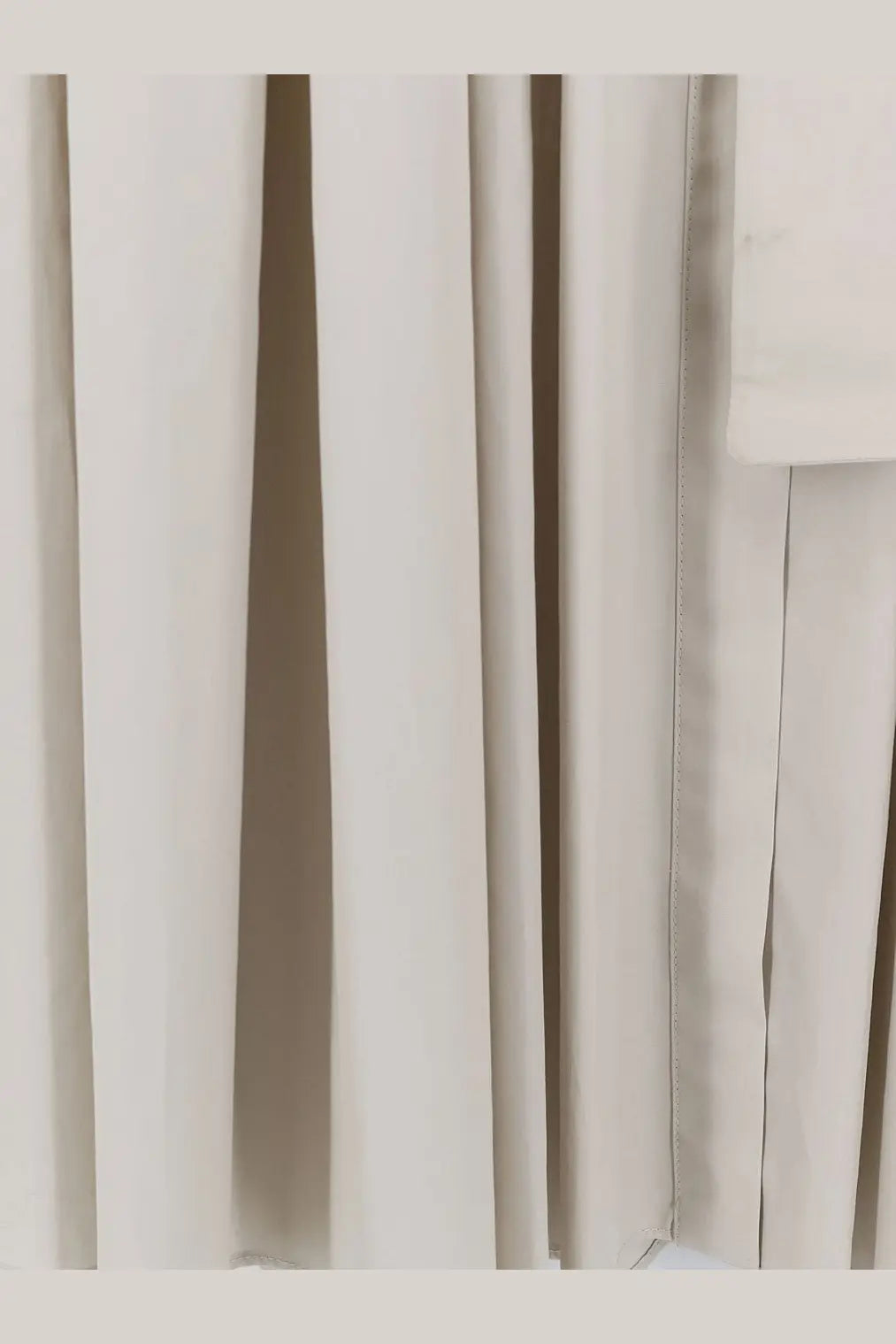 Off-white pleated cotton fabric curtain with smooth textured surface and neat vertical seams for max mara dress ghiaccio