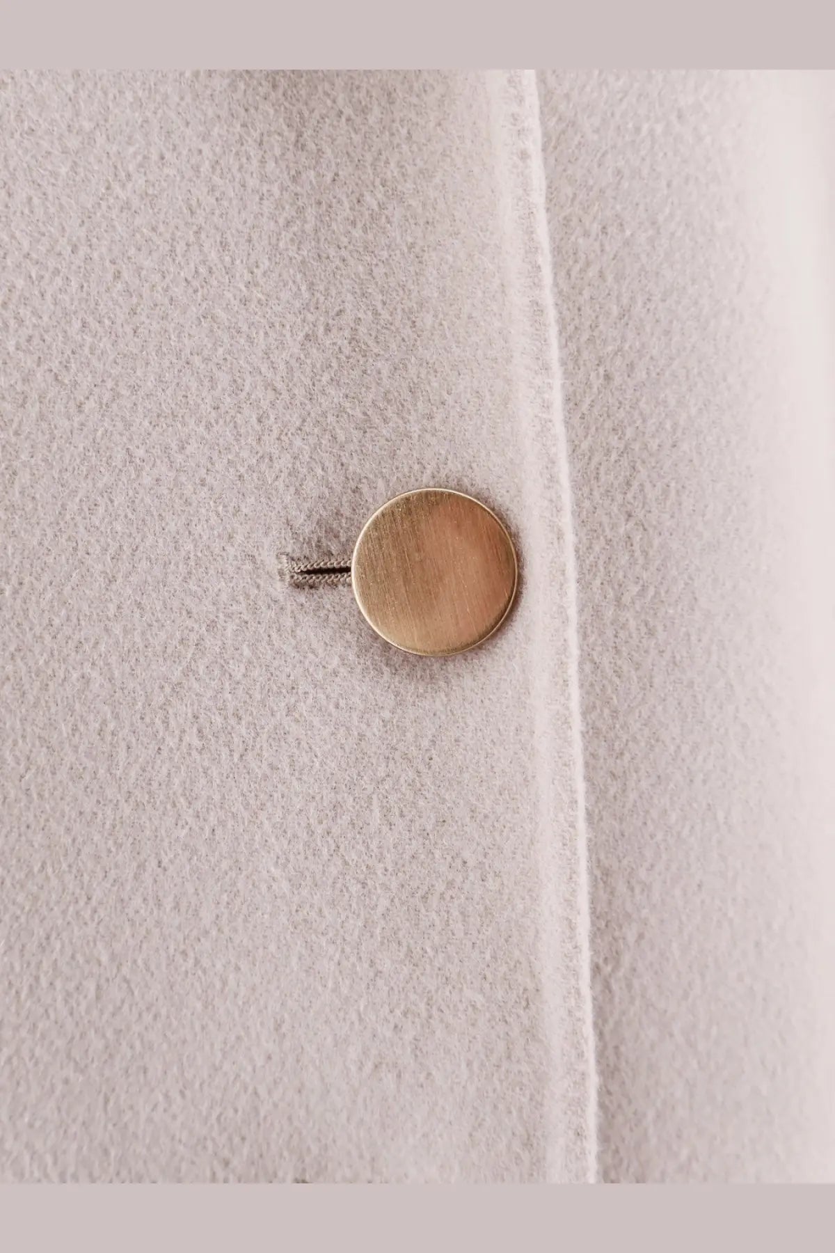 A brushed gold button on a soft light gray wool coat from s max mara women’s smmmargot pure virgin wool peacoat beige