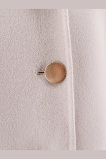 A brushed gold button on a soft light gray wool coat from s max mara women’s smmmargot pure virgin wool peacoat beige