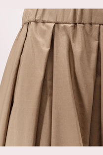 A taupe pleated cotton skirt by S Max Mara with smooth shiny fabric and elastic waistband in beige