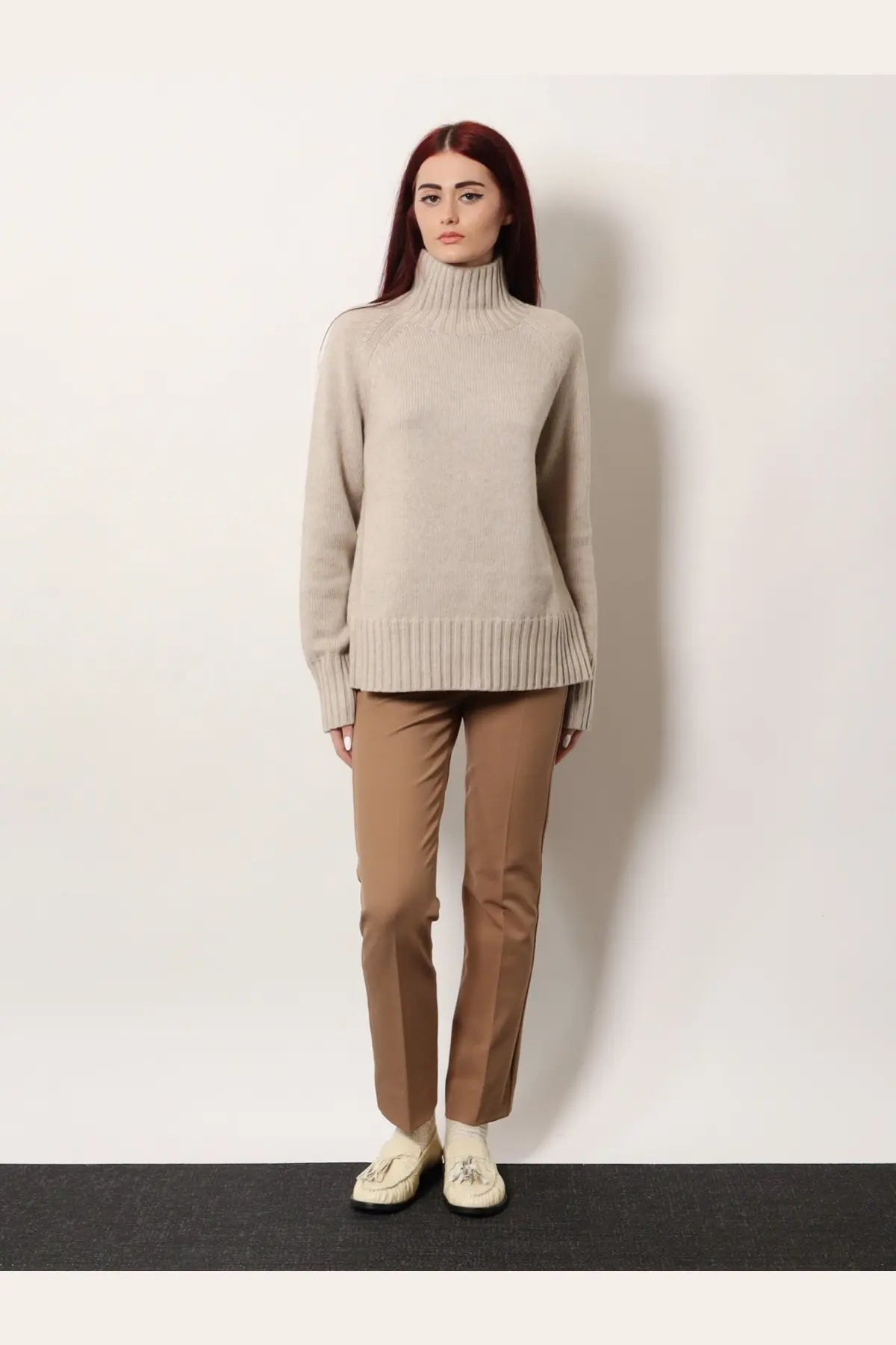 A soft beige ribbed-knit turtleneck sweater paired with s max mara women’s umanita cotton blend trousers beige