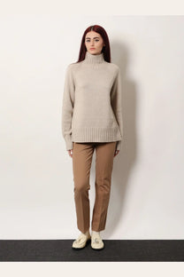 A soft beige ribbed-knit turtleneck sweater paired with s max mara women’s umanita cotton blend trousers beige