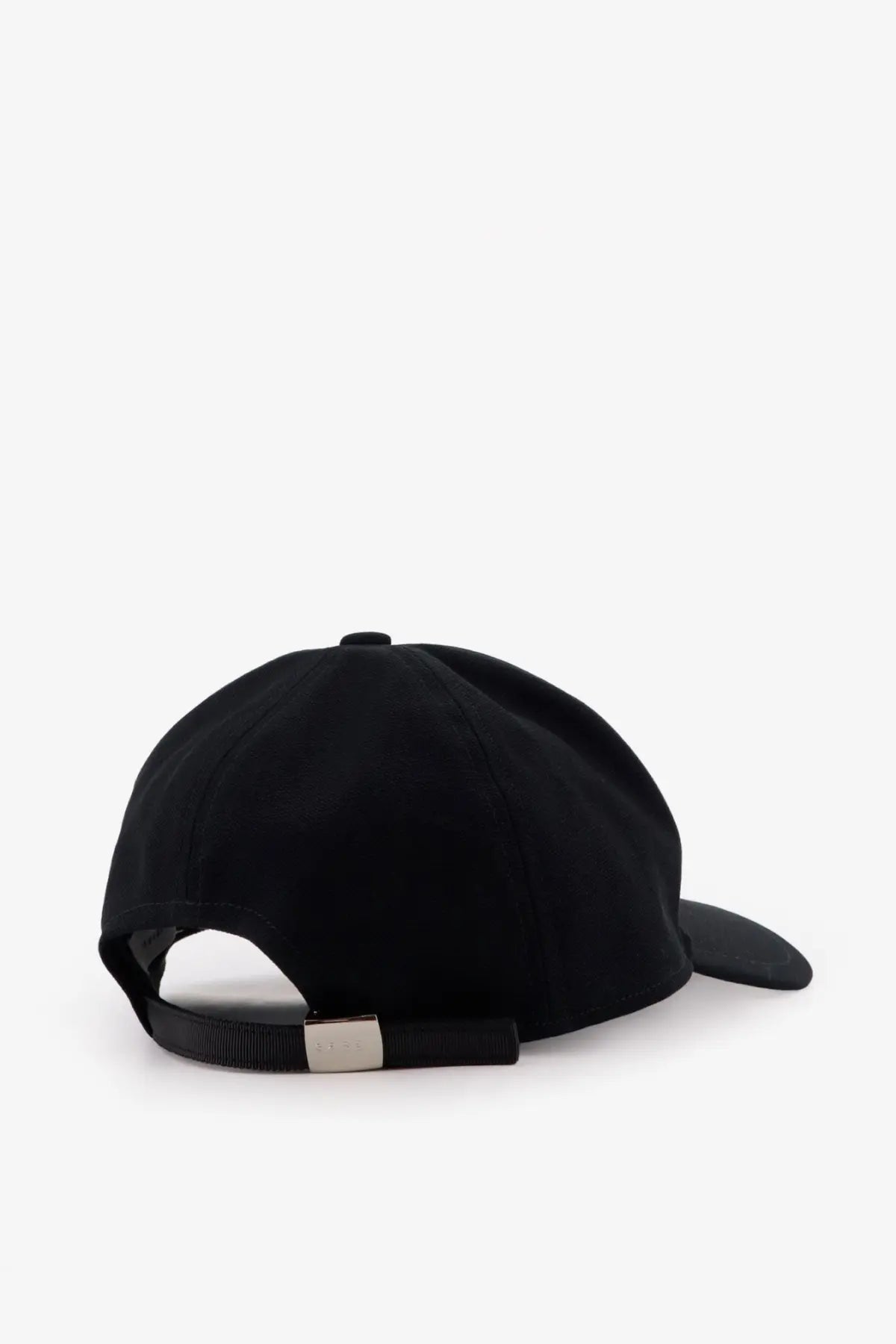Black sacai men’s Carhartt Wip duck baseball hat showing back with silver-toned metal buckle on adjustable strap