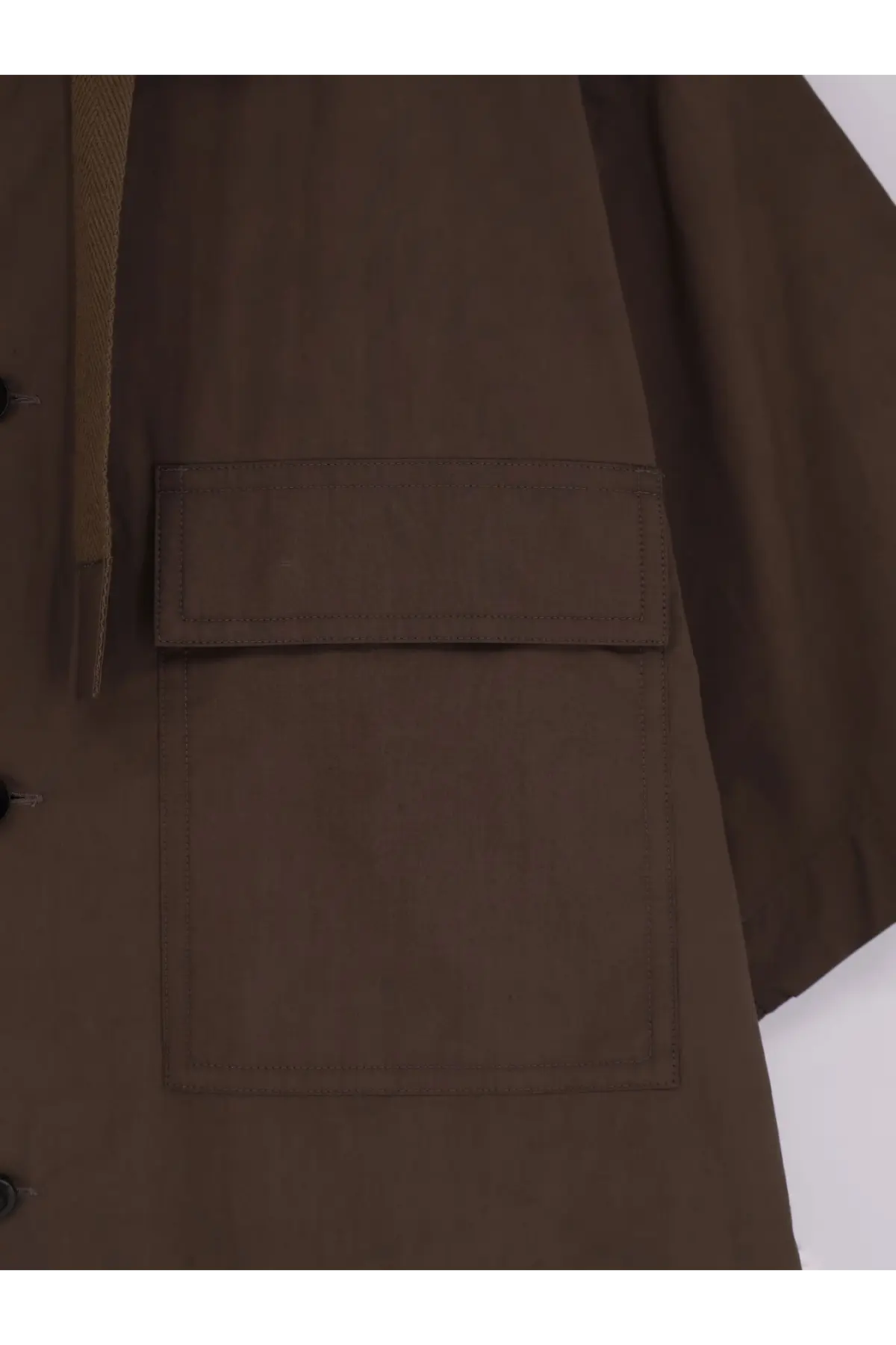 Sacai men’s cotton shirt beige styled with a brown utility jacket featuring flap pockets and subtle textured fabric