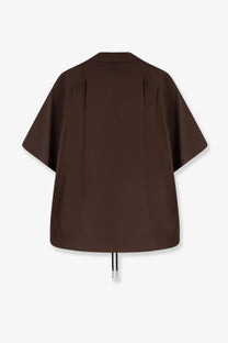 Sacai men’s cotton shirt beige shown from the back with a dark brown oversized short sleeve blouse and pleated detail