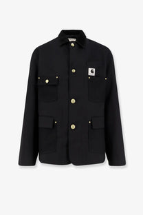 Sacai men’s black Carhartt work jacket featuring gold-tone buttons and a branded patch on the left chest