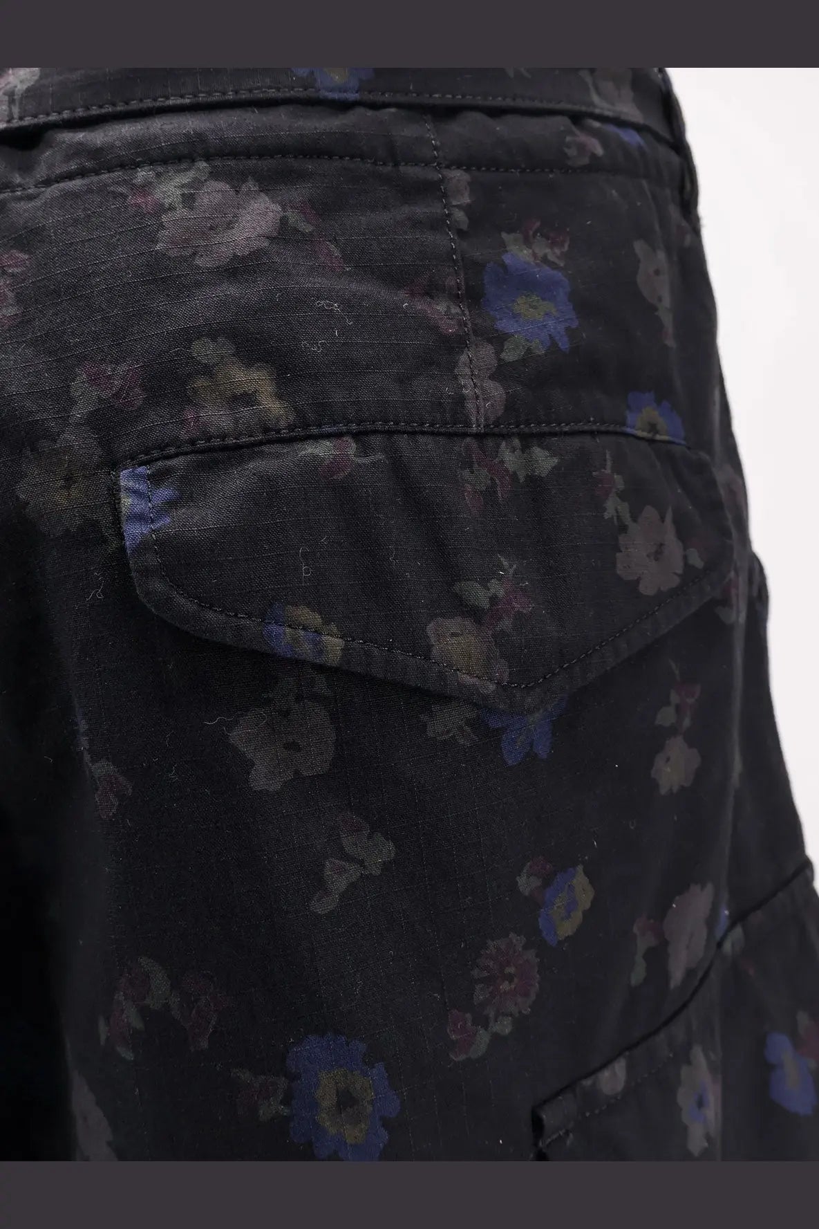 Sacai men’s printed cotton shorts in black dark denim with a subtle floral pattern in muted blues and purples