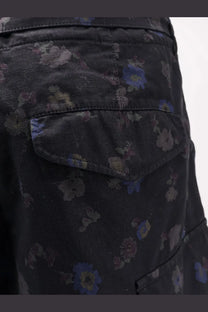 Sacai men’s printed cotton shorts in black dark denim with a subtle floral pattern in muted blues and purples