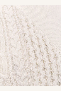 Sacai women’s asymmetrical off-white cotton blend sweater with intricate cable and lace knit patterns