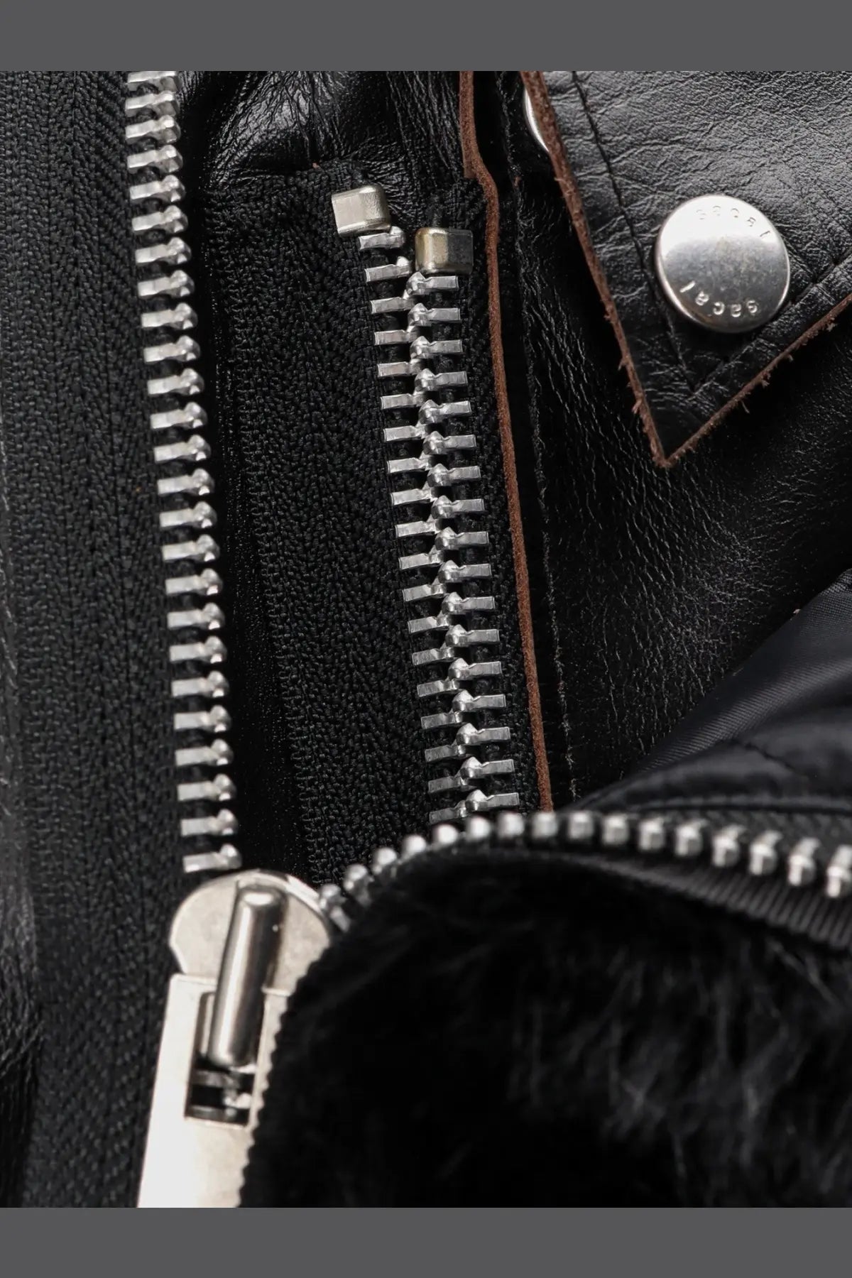 Sacai women’s black leather jacket with silver zippers and branded metal snap button detail