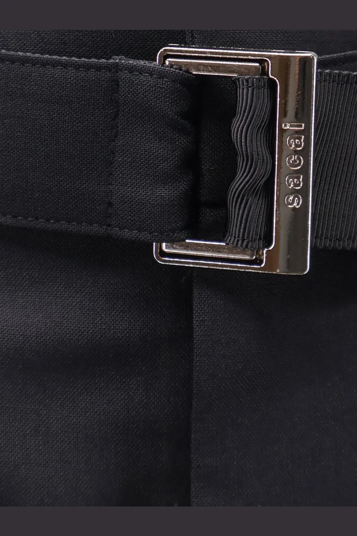 Black fabric belt with silver rectangular gucci buckle paired with sacai women’s black wool blend bermuda shorts