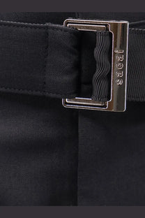 Black fabric belt with silver rectangular gucci buckle paired with sacai women’s black wool blend bermuda shorts