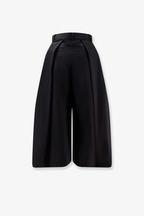 Black high-waisted wide-leg wool blend trousers with tailored silhouette and back pleats from sacai women’s collection