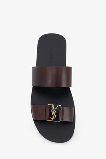 Saint Laurent men’s brown leather slide sandal with gold-tone YSL logo buckle front view