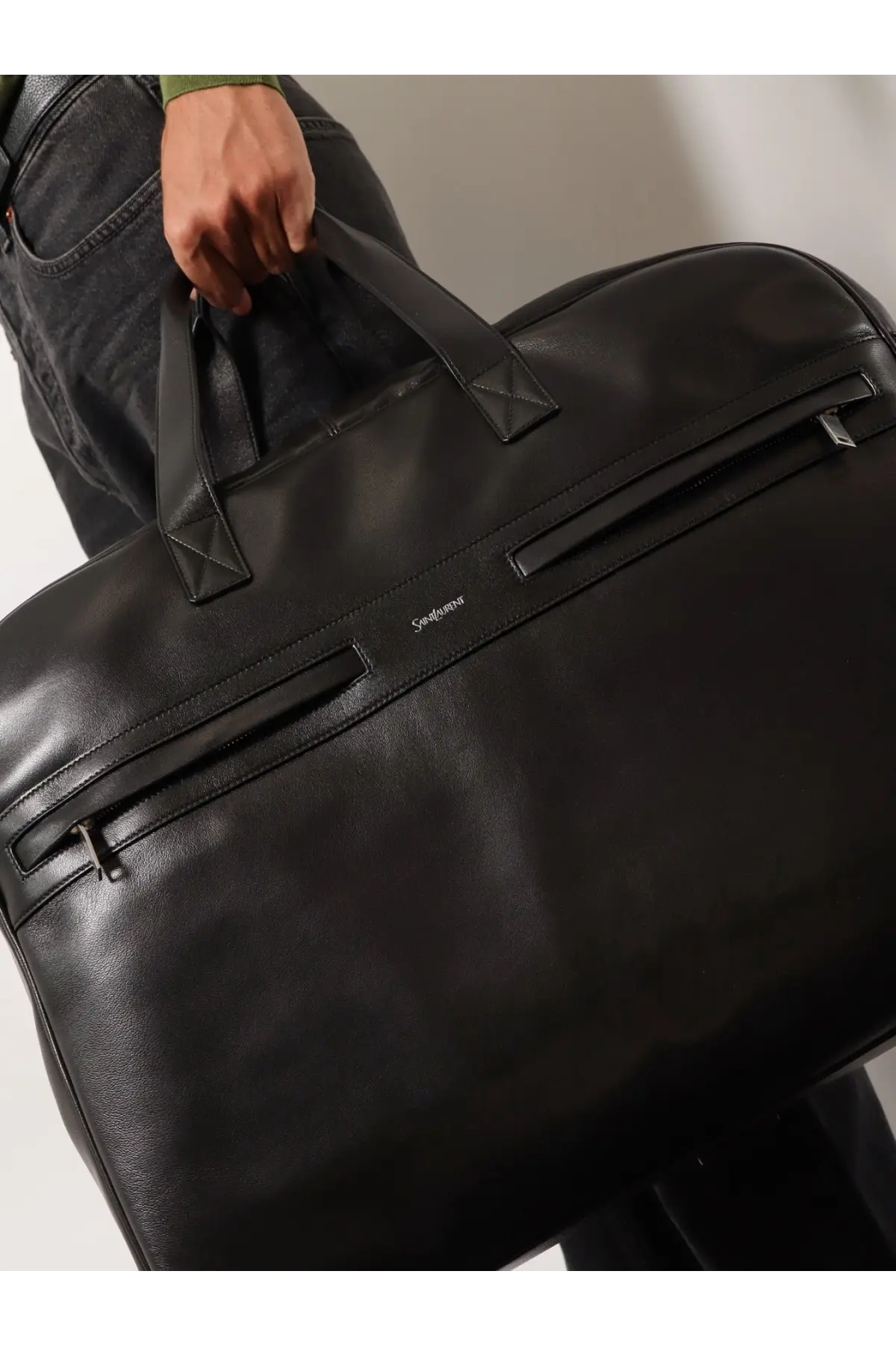 Saint Laurent men’s camp black leather duffel bag with reinforced handles and subtle stitching details