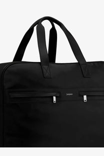 Saint Laurent men’s camp black leather travel bag with black samsonite garment bag featuring sturdy handles and silver zipper pulls
