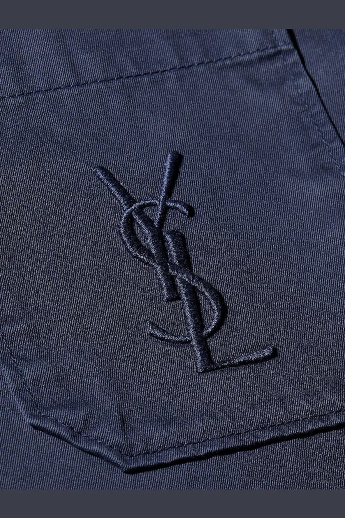 Dark blue embroidered ysl logo on textured cotton pocket of saint laurent men’s cassandre certified cotton overshirt