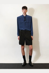 Saint laurent men’s certified cotton shorts black paired with a sleek navy blue satin button-up shirt with chest pockets