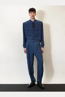 A man wearing a saint laurent men’s certified viscose and silk navy blue long-sleeved button-up shirt with chest pockets
