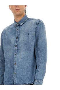 Saint Laurent men’s blue denim Cassandre button-up shirt with subtle faded wash and small embroidered logo on left chest
