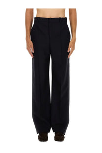 Black wide-leg Saint Laurent men’s high waist trousers with structured tailored fit and clean creases