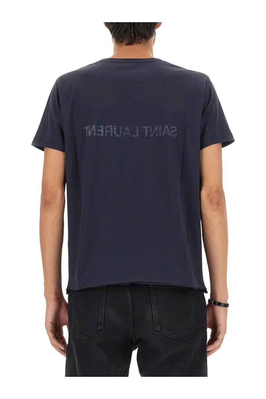 Dark navy blue saint laurent men’s inverted shirt showing back with subtle tonal logo print across the back