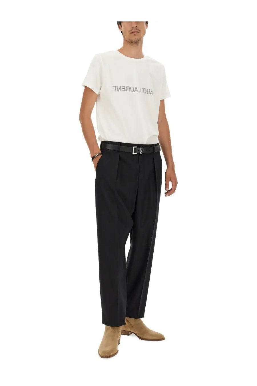 Black pleated trousers with a sleek tailored fit paired with saint laurent men’s inverted shirt white front view