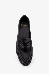 Saint Laurent men’s leather loafers in black with ruffled design and gold-tone ysl logo detail
