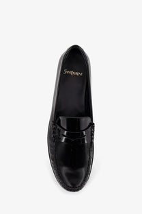 Saint Laurent men’s black patent leather loafers with a glossy finish and braided detailing